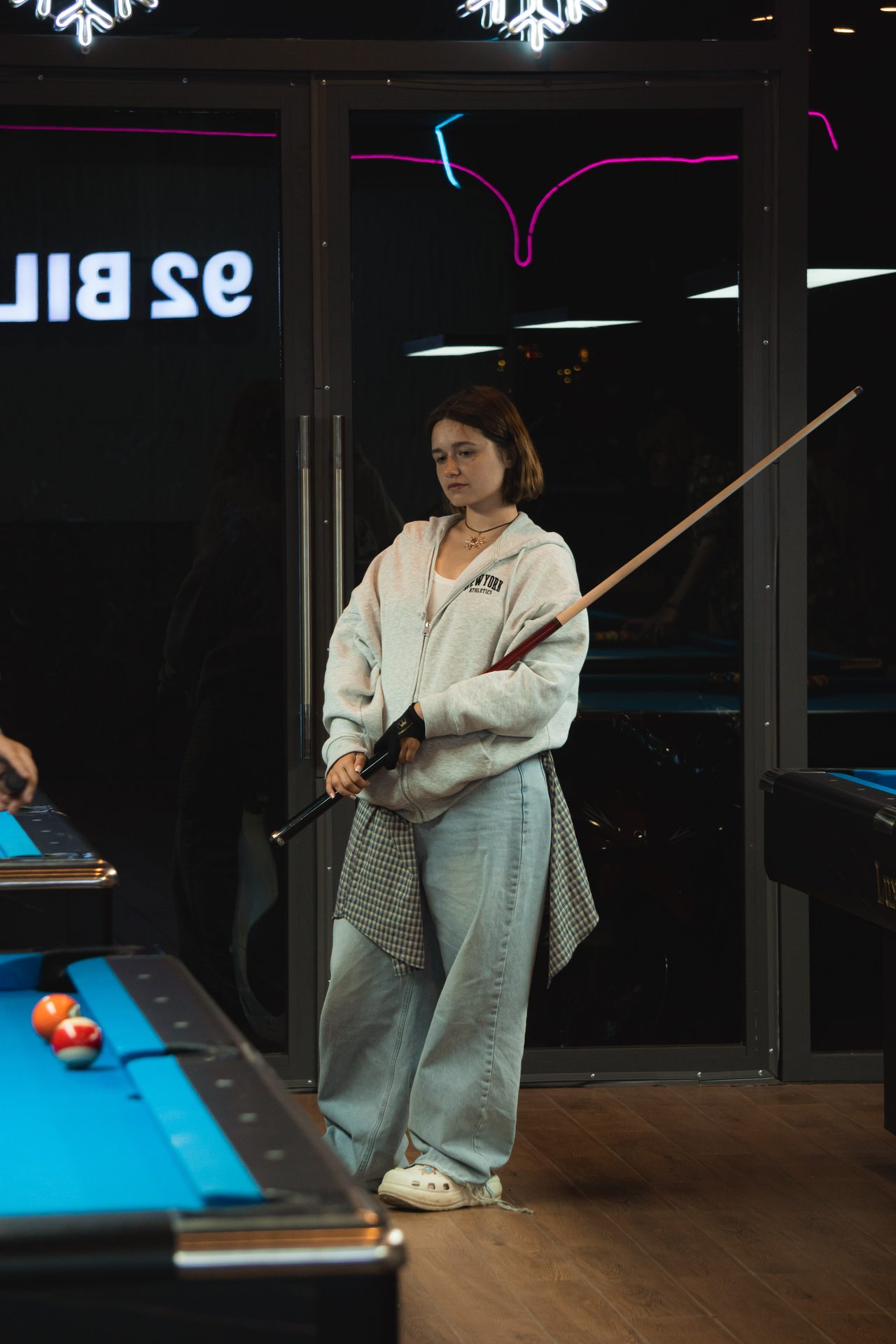 A regular lining up a shot at 92 Billiards Club